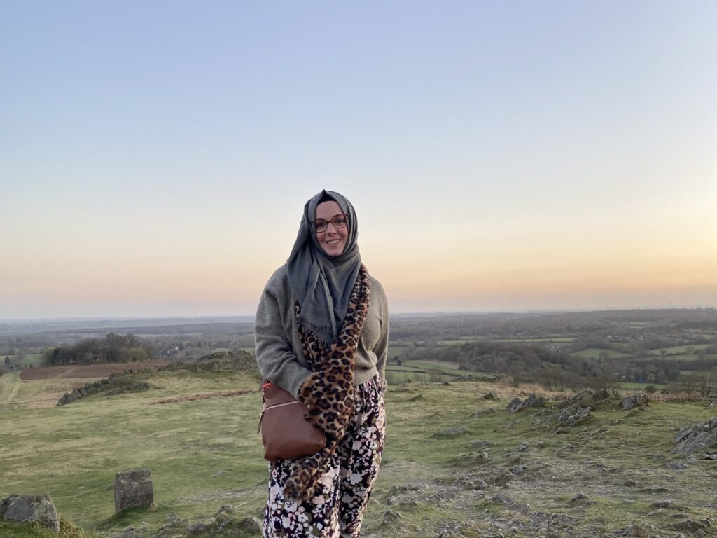 Cherry Aisha stood with the sunset and horizon behind her to sight the moon.
